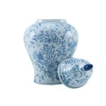 Ceramic urn with floral and bluebird pattern and white background with lid leaning against side of urn.